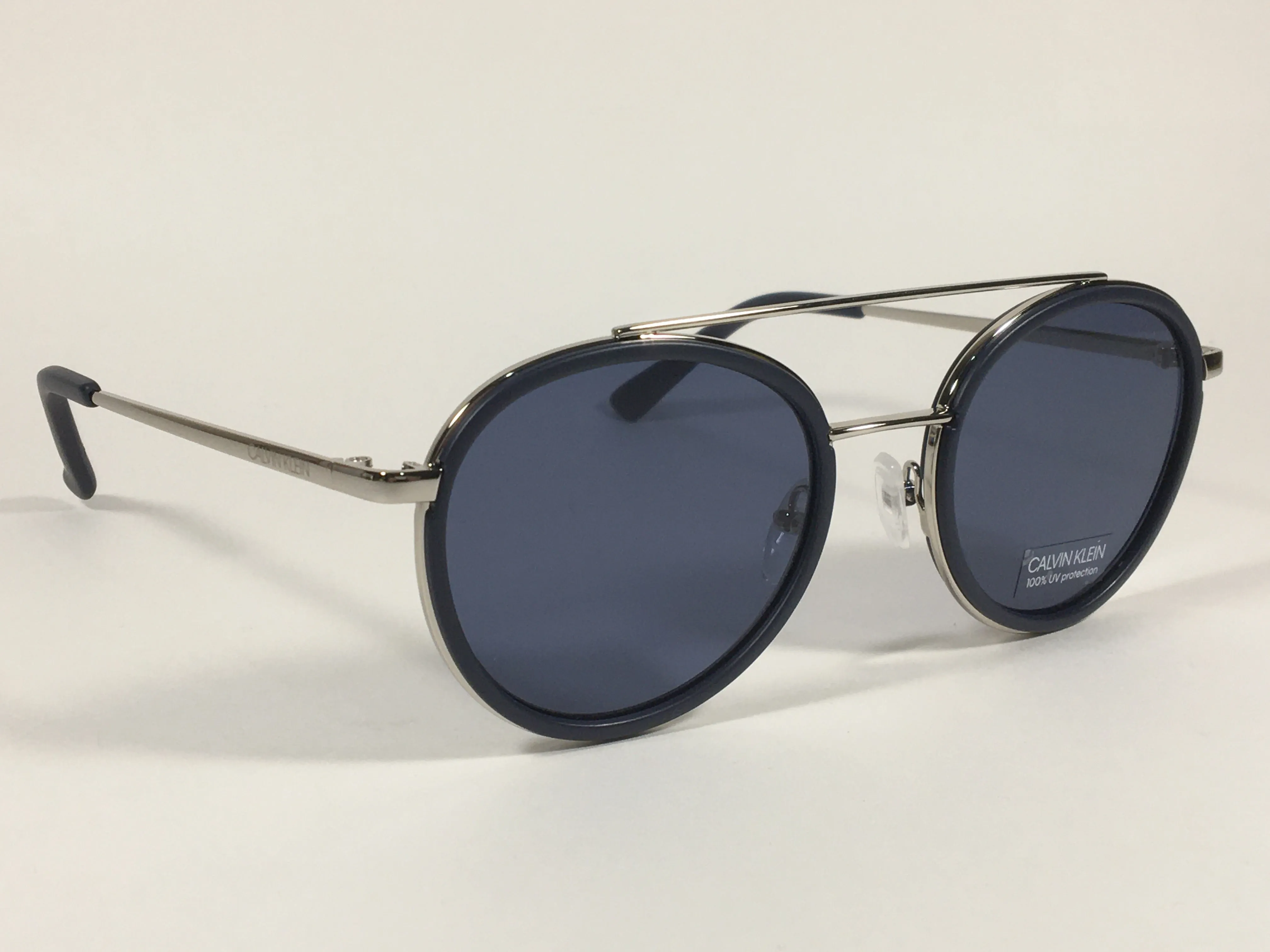 Calvin Klein CK19131S 410 Round Sunglasses Navy Blue And Silver Frame Gray Lens